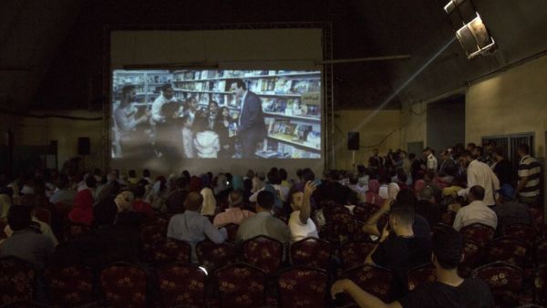 Palestinians attend the screening of "10 Years" at Samer Cinema in Gaza City on August 26, 2017. The Samer Cinema in Gaza City, the oldest in the strip and was built in 1944 but closed for decades, hosted a special screening of a film about Palestinians in Israeli prisons. (AFP)
