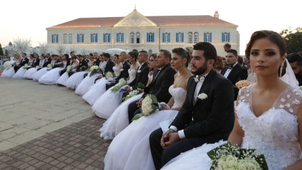 Lebanese Maronite Christian couples take part in a mass wedding at the Maronite Patriarchate in Bkerke on September 3, 2017. Twenty-six couples got married during the event organised by the Maronite league. (AFP)