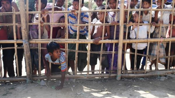 A young Rohingya Muslim refugee passes through a temporary bamboo barricade to collect cooked food at the Thankhali refugee camp in Bangladesh's Ukhia district on Nov. 10, 2017 (AFP)