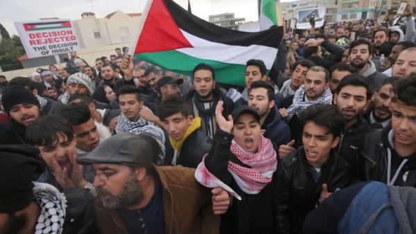 Protesters shout slogans and wave the Jordanian flag during a demonstration near the American Embassy in Amman against U.S. President Donald Trump's decision to recognise Jerusalem as the capital of Israel. (KHALIL MAZRAAWI / AFP)