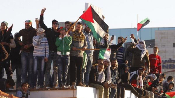 Protesters shout slogans and wave Palestinian flags during a demonstration against the US president's decision to recognize Jerusalem as the capital of Israel, near the American embassy in Amman, on December 8, 2017 (Ahmad ABDO/AFP)