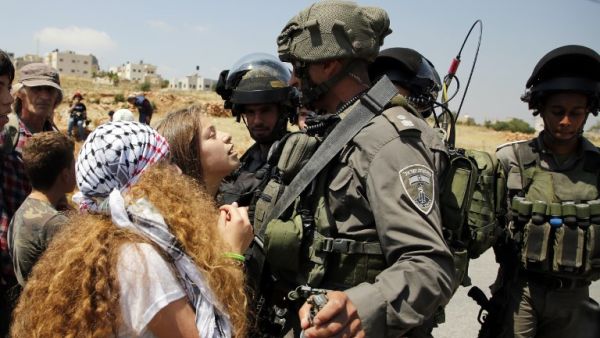 17-year-old Ahed Tamimi (C) protesting before Israeli forces in the West Bank village of Nabi Saleh, north of Ramallah, on May 12, 2017, after a demonstration following Friday prayers in solidarity with Palestinian prisoners on hunger strike in Israeli jails (Abbas Momani/AFP)
