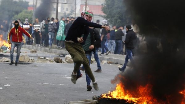 A Palestinian protester throws a stone during clashes with Israeli forces near the Huwara checkpoint south of Nablus in the Israeli-occupied West Bank as protests continue in the region.
(Jaafar ASHTIYEH / AFP)