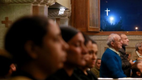 Egyptians gather during the funeral of the victims of the attack on the Saint Mina Coptic church, on Dec. 29, 2017, at a church south of the capital Cairo.
(Samer ABDALLAH / AFP)