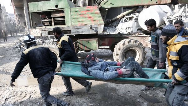 Volunteers from the Syrian Civil Defence (known as the White Helmets) carry a girl on a stretcher after digging her out of the rubble following an air strike on Hamouria, in the besieged rebel-held Eastern Ghouta on Jan. 9, 2018 (ABDULMONAM EASSA / AFP)
