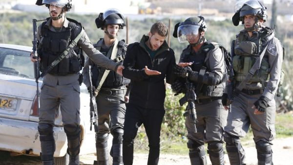 Israeli forces detain a Palestinian youth during clashes following a demonstration calling for the release of Palestinian prisoners from Israeli jails, on Jan. 13, 2018, in the West Bank village of Nabi Saleh (ABBAS MOMANI / AFP)