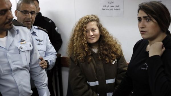 Sixteen-year-old Palestinian Ahed Tamimi (2-R), a well-known campaigner against Israel's occupation, standing for a hearing in the Israeli military court at Ofer military prison in the West Bank village of Betunia on Jan. 15, 2018 (THOMAS COEX / AFP)