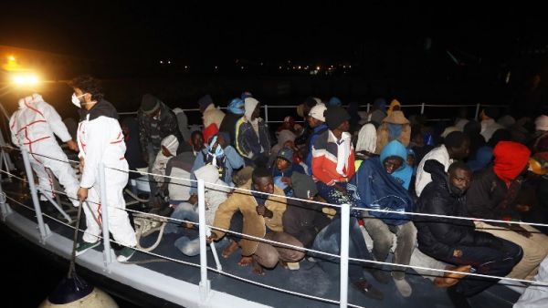 Illegal migrants from Arab and African nationalities arrive at a naval base in the capital Tripoli late on Jan. 15, 2018, after they were rescued off the coast of Zuwara, 130 kilometers (81 miles) West of the Libyan capital (Mahmud TURKIA / AFP)