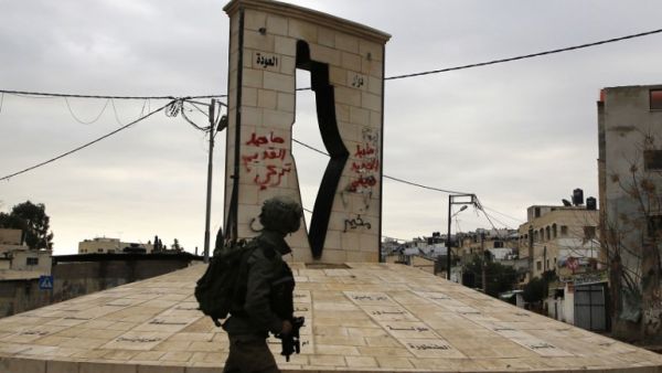 A member of the Israeli forces walks during a military operation in Jenin, in the north of the occupied West Bank, on Jan. 18, 2018 (Jaafar ASHTIYEH / AFP)
