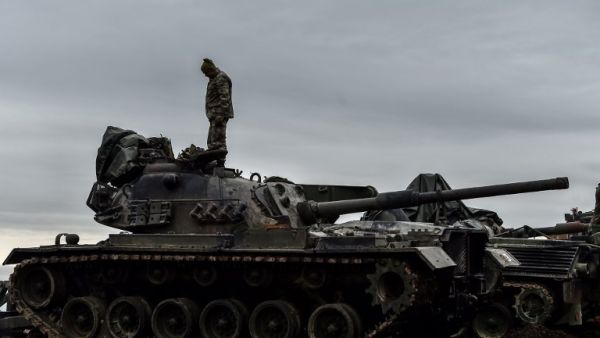 A Turkish soldier stands on a tank near the Syrian border at Hassa, in Hatay province on January 24, 2018, as part of the operation "Olive Branch", launched a few days ago. The operation aims to oust the People's Protection Units (YPG) militia, which Turkey considers to be a terror group, from its enclave of Afrin.
(OZAN KOSE / AFP)