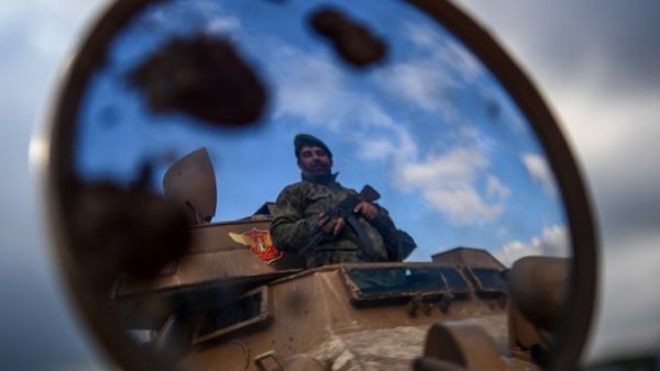 A Turkish-backed Syrian rebel fighter mans a checkpoint in the Syrian town of Azaz, on a road leading to Afrin, on Jan. 27, 2018 (Ozan KOSE / AFP)