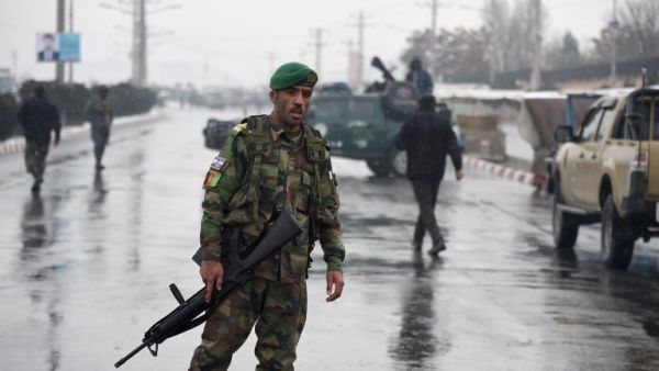 Afghan security personnel stand guard near the site of an attack near the Marshal Fahim Military Academy base in Kabul on Jan. 29, 2018 (WAKIL KOHSAR / AFP)