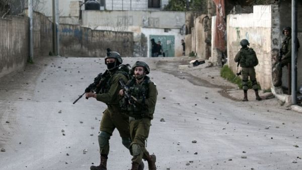 Israeli soldiers advance through the Palestinian village of Burqin in the northern occupied West Bank, during an army search operation on Feb. 3, 2018 (JAAFAR ASHTIYEH / AFP)