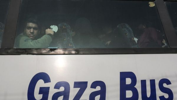 A Palestinian looks out of the window of a bus as travelers arrive at the Rafah border crossing in the southern Gaza Strip to cross into Egypt, after it was opened by Egyptian authorities for humanitarian cases on Feb. 7, 2018.
(SAID KHATIB / AFP)