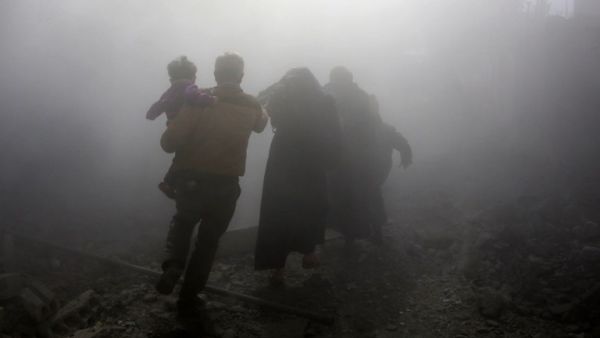A Syrian family walks through a dust cloud while fleeing from reported regime air strikes in the rebel-held town of Jisreen, in the besieged Eastern Ghouta region on the outskirts of the capital Damascus, on Feb. 8, 2018. A fourth consecutive day of heavy regime bombing raids on the rebel-held enclave of Eastern Ghouta near Damascus killed 22 civilians on Feb. 8, a monitor said.
(ABDULMONAM EASSA / AFP)