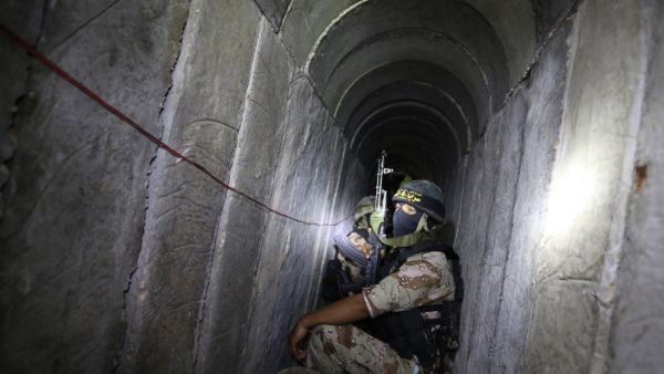 Palestinian militants squat in a tunnel during military training in southern Gaza (AFP/File Photo)	