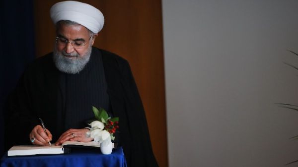 Iranian President Hassan Rouhani signs a book as he attends a meeting with Antonio Guterres, the Secretary-General of the United Nations, during the 73rd United Nations (U.N.) General Assembly on September 26, 2018 in New York City (AFP)