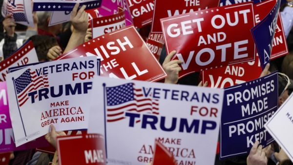 Supporters wave campaign signs during a capmpaign rally for Republican Senate candidate Mike Braun and attended by U.S. President Donald Trump. (AFP/FILE)