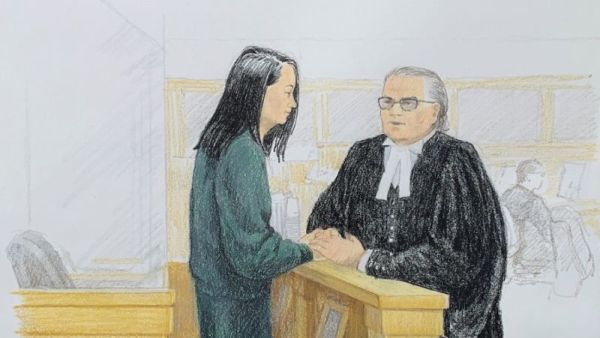 In this courtroom sketch by Jane Wolsak and released to AFP by the artist, Meng Wanzhou (L), Huawei's chief financial officer, speaks with lawyer David Martin in the courtroom in Vancouver. (AFP/ File)