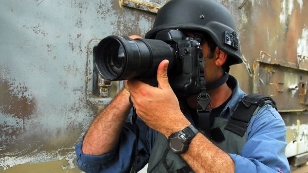 Being a photographer in a country rapidly descending into conflict (Shutterstock).
