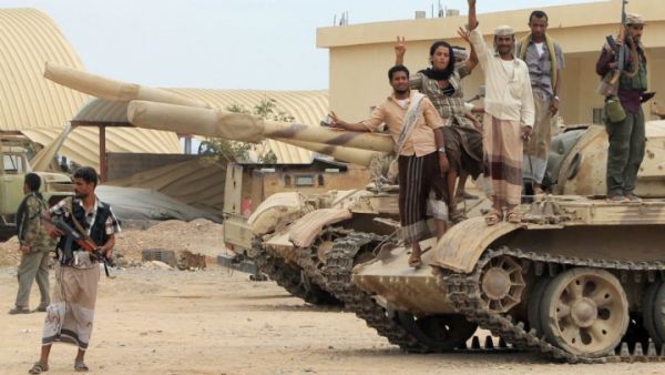 Anti-Houthi militants stand on a tank in southern Yemen (AFP/File Photo)