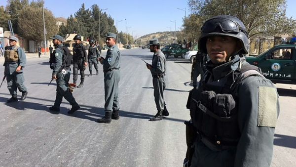 Policemen gather outside the building where the attack occurred (AFP)