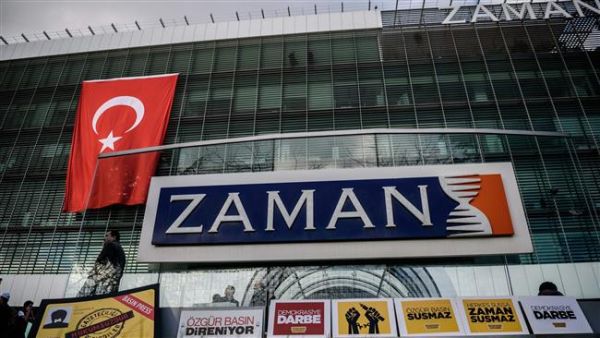 The logo of Turkish daily newspaper Zaman is seen on the headquarters building as people demonstrate in support of the newspaper in Istanbul on March 4, 2016. (AFP/File)