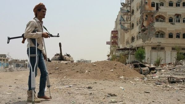 A fighter walks with crutches in Yemen's second city of Aden (AFP/File Photo) 