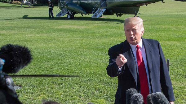 I dare you: President Donald Trump challenged a TV reporter on Monday to take his camera crew into the migrant caravan in southern Mexico. (AFP/FILE)