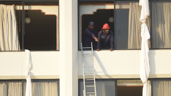 Man looking out the window (AFP/File Photo)