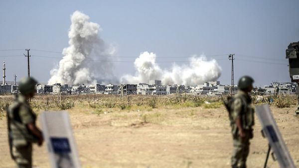 Smoke rises in the Syrian city of Kobani from heavy fighting seen from the Turkish border. (AFP/File)
