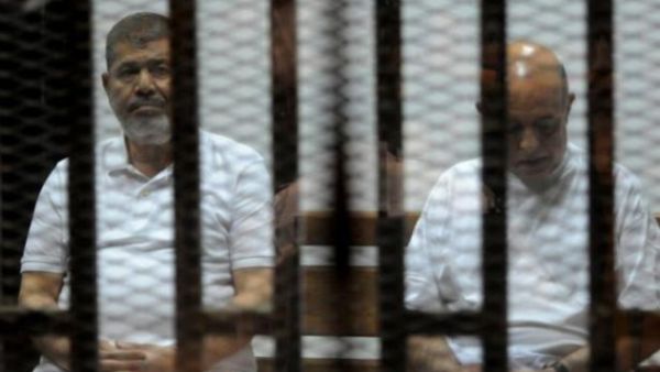 Ousted Egyptian president Mohamed Morsi and his former chiefof staff Rafaa al-Tahtawi on trial on Oct. 14, 2014 in Cairo. (AFP/File)
