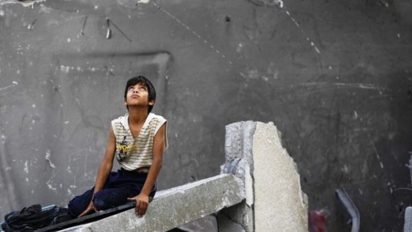 A Palestinian boy sits on rubble following an Israeli air strike in Gaza City, June 22, 2014. (AFP/File) A Palestinian boy sits on rubble following an Israeli air strike in Gaza City, June 22, 2014. (AFP/File)