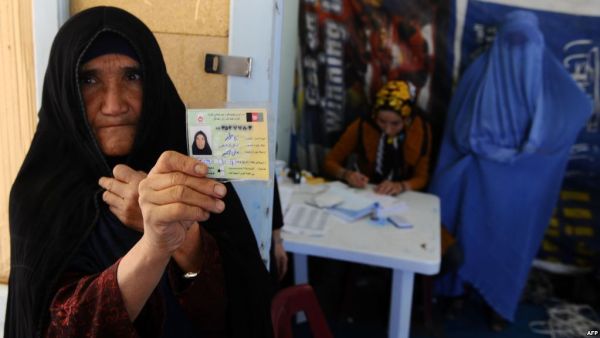 An elderly woman displays her identification card to vote in Afghanistan's forthcoming presidential election at a registration center in Herat.(AFP/File)