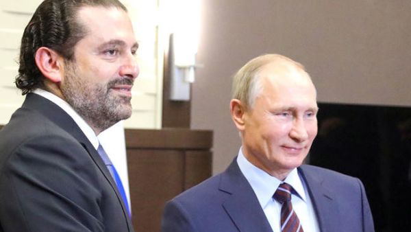 Russian President Vladimir Putin, right, shakes hands with Lebanese Prime Minister Saad Hariri during a meeting in Sochi on Wednesday. (AFP)