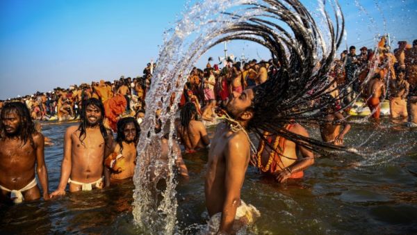 Indian sadhus (Hindu holy men) take a dip into the water of the holy Sangam -- the confluence of the Ganges, Yamuna and mythical Saraswati rivers -- during the auspicious bathing day of Makar Sankranti at the Kumbh Mela in Allahabad (AFP)