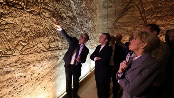 French President Emmanuel Macron (C) and his wife Brigitte (R), accompanied by Egyptian Minister of Antiquities Khaled el-Enany (L) visit the temple of Abu Simbel in southern Egypt  (AFP)