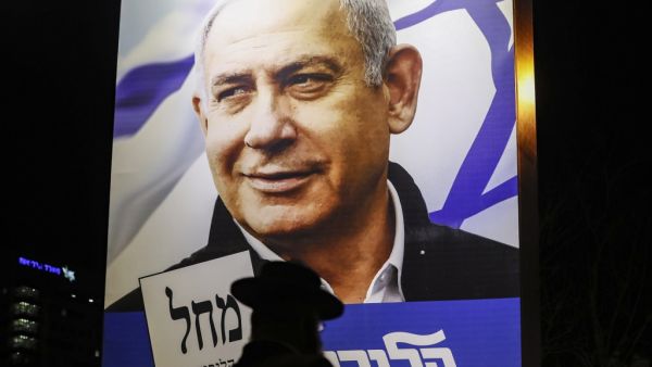 An Ultra-Orthodox Jewish man passes by a billboard showing a Liked Party electoral billboard depicting Israeli Prime Minister Benjamin Netanyahu in Jerusalem on April 7, 2019, two days ahead of the parliamentary polls. 
Ahmad GHARABLI / AFP