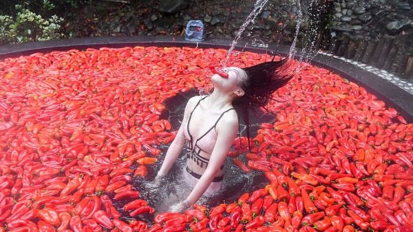 This girl is on fire: A woman takes part in the chilli-eating contest at a scenic spot in Yichun city, Jiangxi province on Sunday (Instagram)