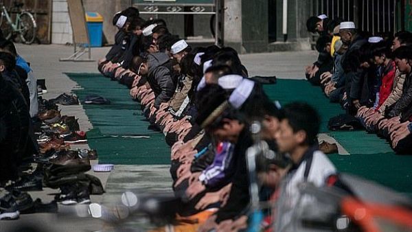 Ethnic Hui Muslim men praying at Nanguan Mosque during Friday prayers in Linxia, Gansu (AFP)