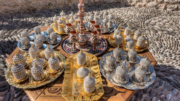 Copperware, beaded decorated cans, tea caraffe, silver and golden ornamented plates (Shutterstock)