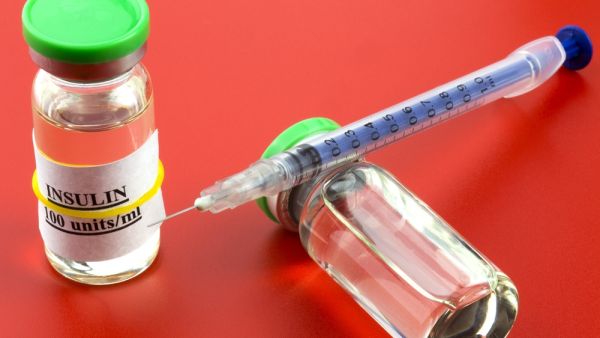 Two vials with insulin hormone and single use insulin syringe (Shutterstock)