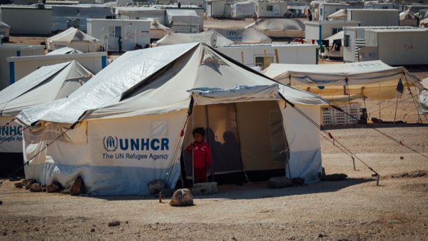 Syrian child standing outside her tent at the Zaatari Refugee camp in Mafraq, Jordan (Shutterstock)