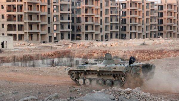 An opposition tank drives through a government-held neighborhood in Aleppo on August 5, 2016. (AFP/Omar Haj Kadour)