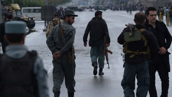 Afghan security forces at the site of a car bombing earlier on April 19. (AFP/Shah Marai)