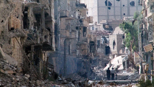 Syrians walk through a destroyed neighborhood in Deir Ezzor. (AFP/File) Syrians walk through a destroyed neighborhood in Deir Ezzor. (AFP/File)