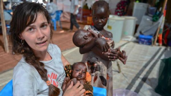 An MSF worker holds a baby outside a clinic in Juba, South Sudan. (AFP/File)