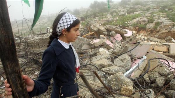 A Palestinian girls looks at the remains of her demolished home. (AFP/File)