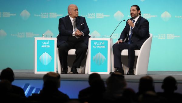 Lebanese Prime Misister Saad Hariri (R),speaks with journalist Emad el-Din Adeeb, during the opening session of the World Government Summit in Dubai, on February 10, 2019.  (AFP)