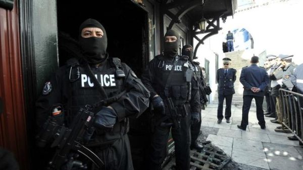 Tunisian special forces stand guard outside a mausoleum ravaged by fire in what is thought to have been an arson attack on Sunday in Sidi Bou Said. (AFP PHOTO /FETHI BELAID)